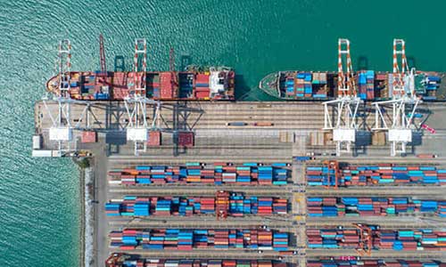 bird's eve view of a container yard with docked ships