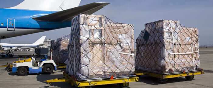 packages wrapped in cargo rope netting ready for loading