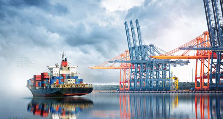 cargo ship filled with containers preparing to dock at the port