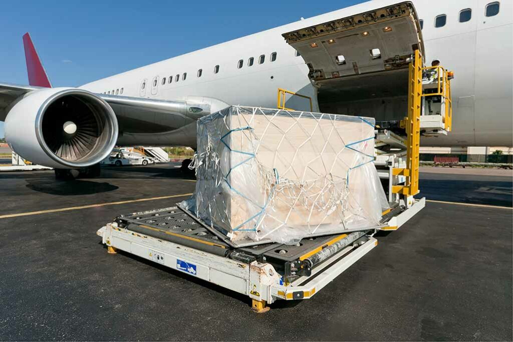 packages wrapped in rope netting and loaded on a conveyer belt