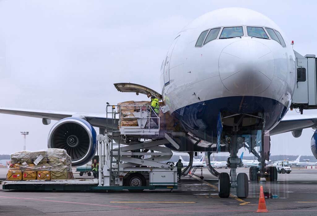front view of plane at the tarmac receiving cargo
