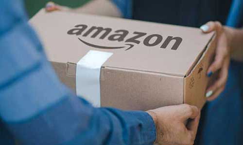 man's arms holding an amazon-labeled package