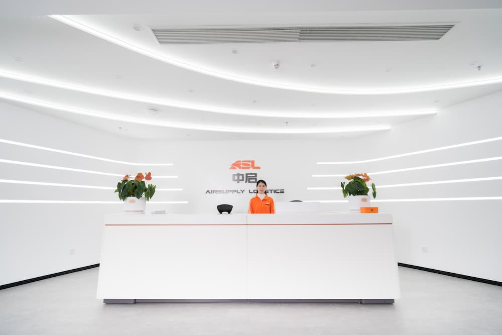 asl company reception desk with a woman standing behind the desk