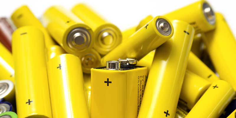 pile of batteries with yellow cover
