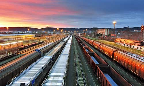 aerial shot of a train yard with several train pieces