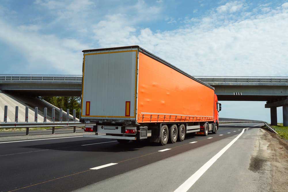 angled view of an orange delivery truck