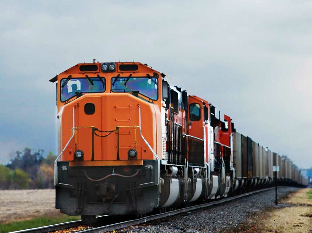 orange train moving cargo from one location to another