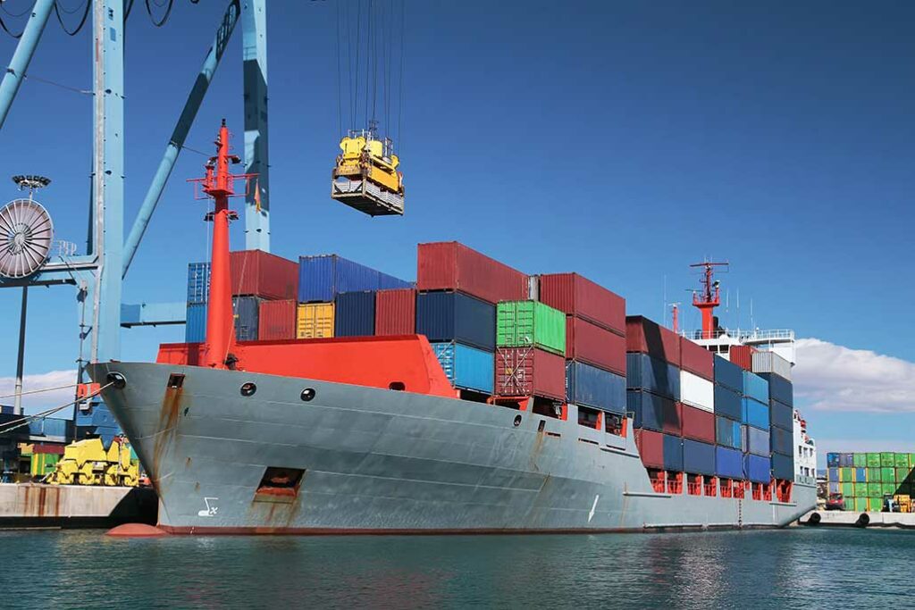 cargo ship receiving containers via a crane
