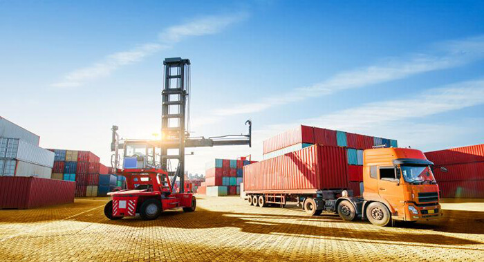 forklifts and cargo trucks and containers in the port