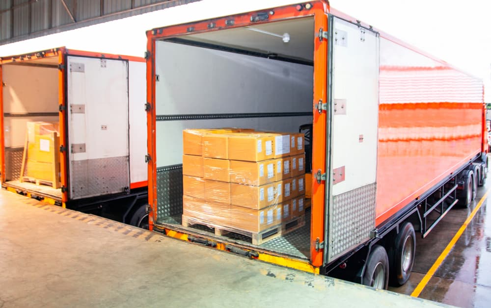open trailer with a pallet of packages loaded in