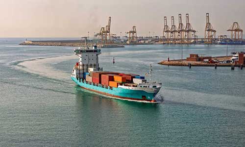 cargo ship moving on the sea carrying several storage containers