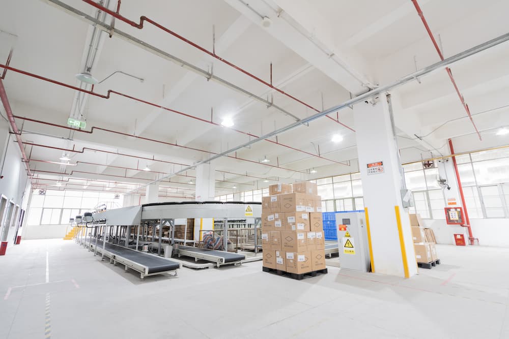 several cardboard boxes stacked in a fulfillment warehouse